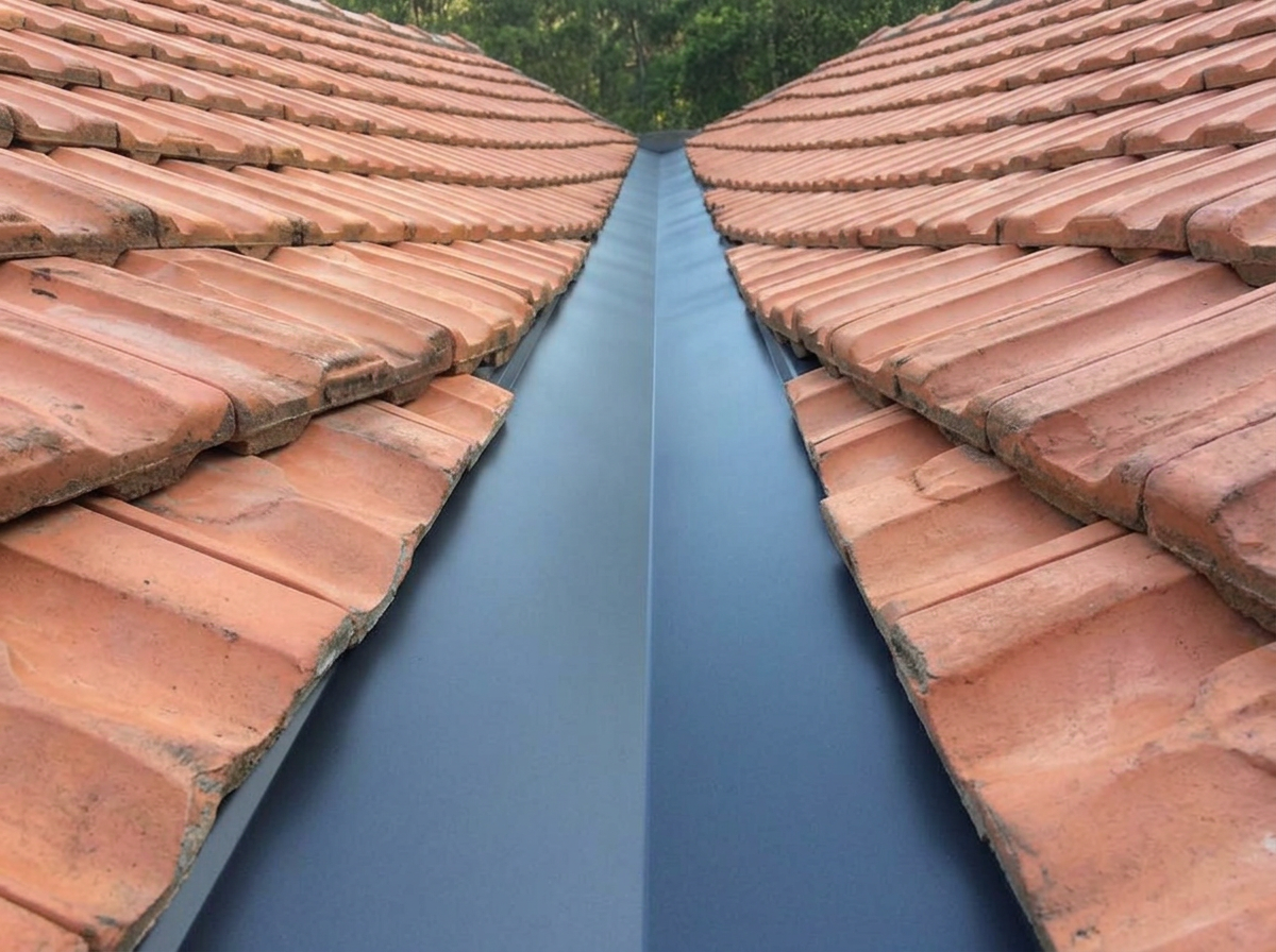 Same valley with clean new Colorbond valley iron and re-cut tiles either side